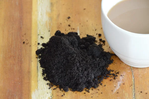 Coffee cup and coffee scrub on table