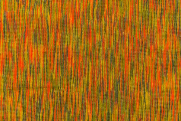 Texture of mottled fabric with vertical orange and green touches