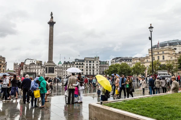 Crowd in Trafalgar square a rainy day