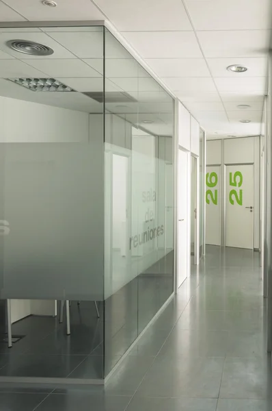 Empty meeting room and corridor  with glass walls in a modern office building