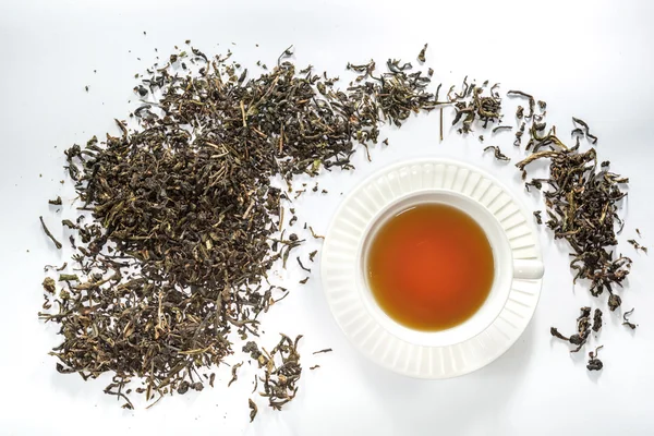 White cup tea and dried tea leaf