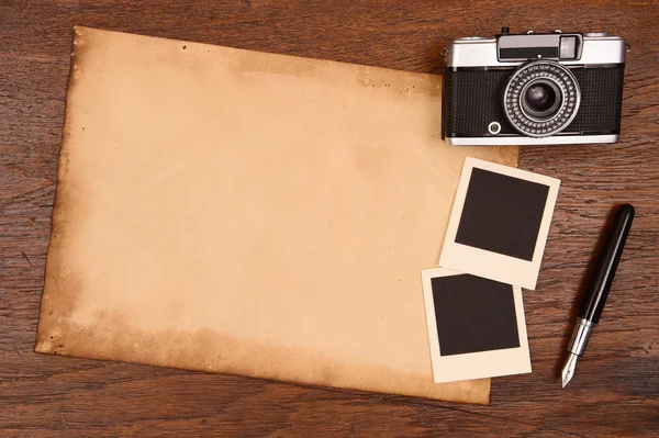 Old paper, ink pen and vintage photo frame with camera