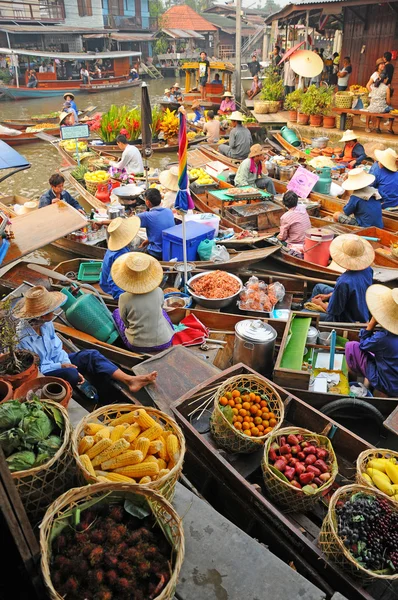 Wooden boats busy ferrying people at Amphawa floating market on April 13, 2011 in Bangkok.