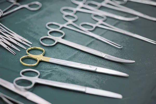 Detail shot of steralized surgery instruments with a hand grabbing a tool