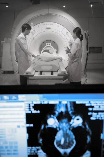 Veterinarian doctor working in MRI scanner room with moniter foreground