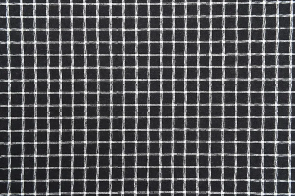 Black and white gingham cloth background with fabric texture