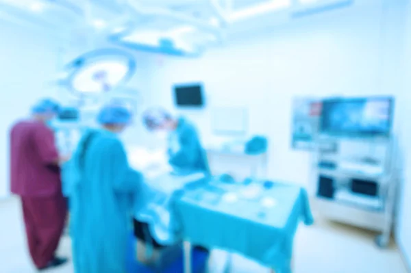 Blur of group of veterinarian surgery in operation room