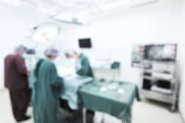 Blur of group of veterinarian surgery in operation room