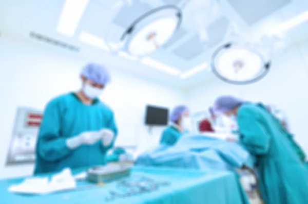 Blur of group of veterinarian surgery in operation room