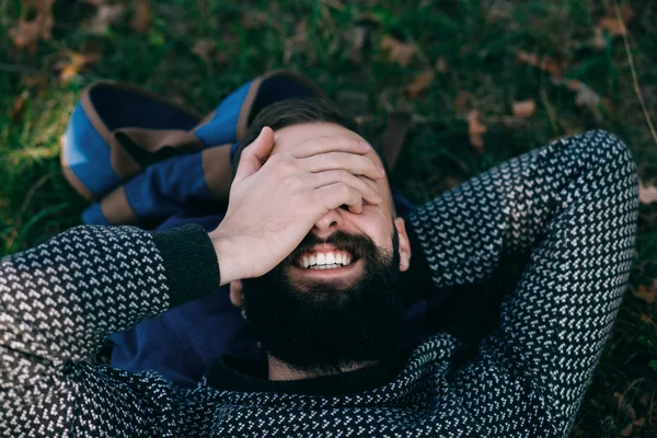 Bearded man smile in summer park