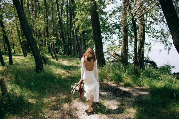 Bride walking in the woods