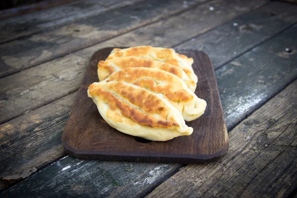 Fried pies on a wooden chopping board