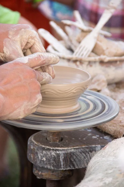 Hands in the clay, four hands molded clay, the clay on a potter\'