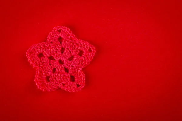 Stars, crocheting of red thread on a red background