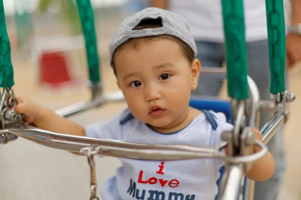 Cute little boy with mom and dad walking in the park