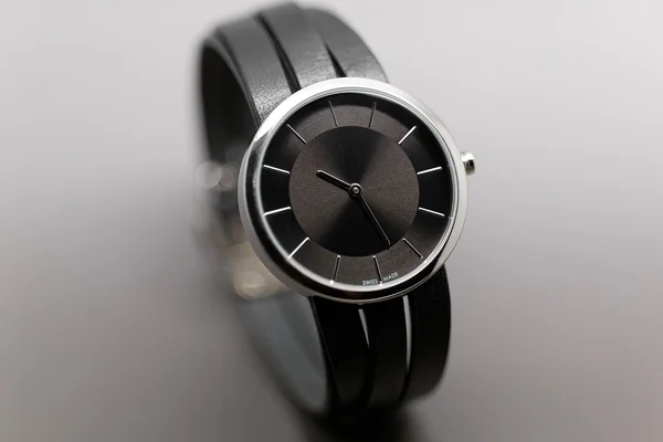 Hand watches with leather strap on the grey background