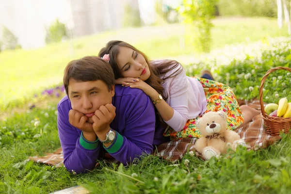 Young couple in the park at picnic. Love story