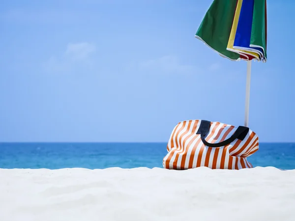 Bag and Umbrella on Sand Beach Summer Holiday Travel