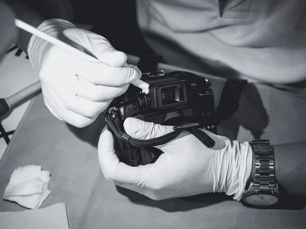 Hand holding Camera cleaning Len and sensor Professional service