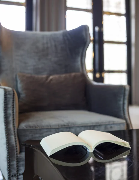 Armchair with pillow  in living room Book on the table