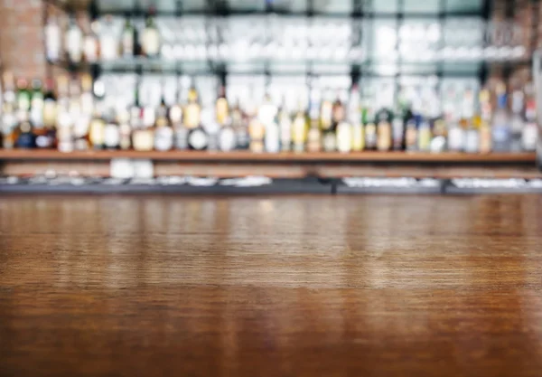 Top wooden table with restaurant Bar Blurred Background