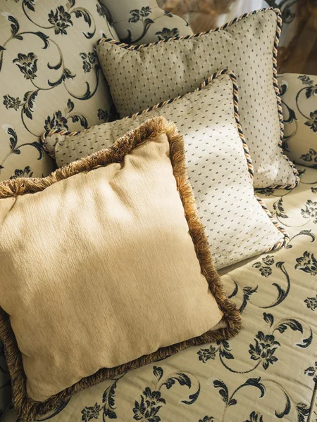 Pillows on sofa with floral pattern fabric