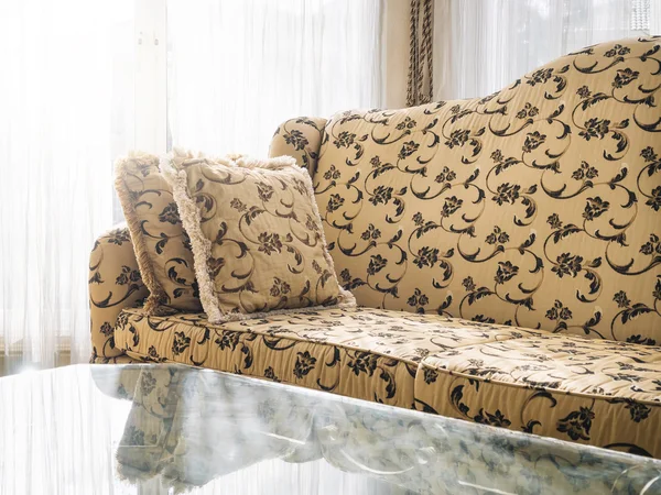 Sofa with pillows with floral fabric