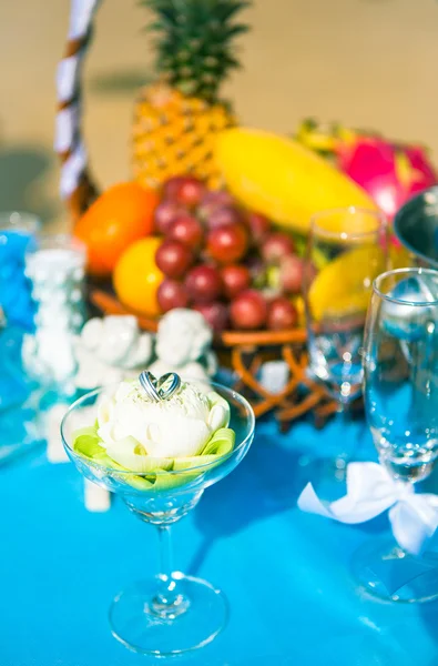 Wedding table with fruit and champagne on the background of the sea