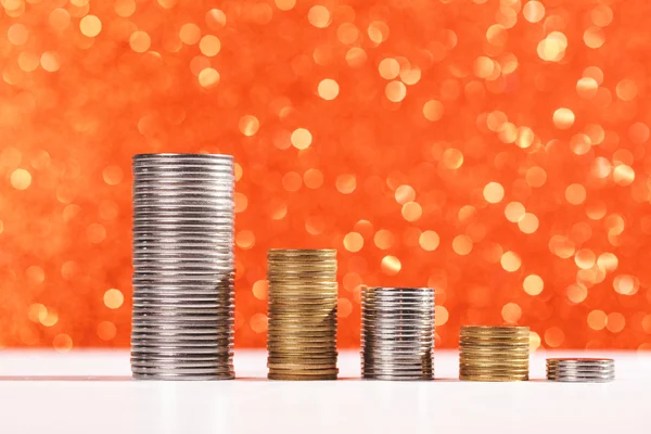 Coins stacks with golden bokeh background
