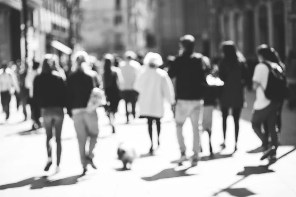 Blurred crowd of walking people in the city