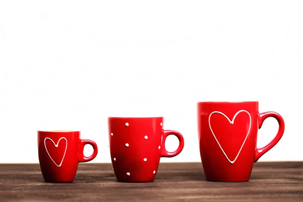 Three red coffee cups