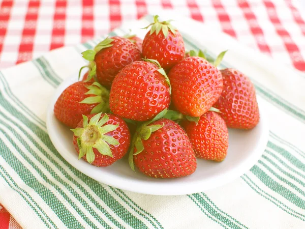Strawberries on checkered table cloth