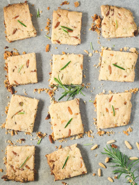 Cookies with rosemary and pine nuts. Vertical image