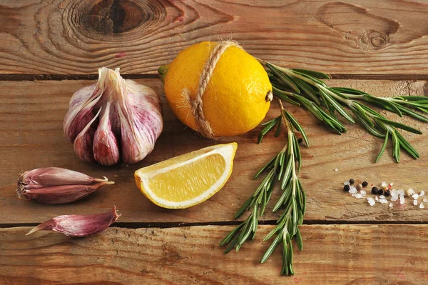 Lemon tied up with string, garlic, rosemary and spices