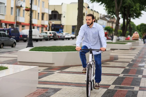 Young hipster man with fixed gear bike on city street