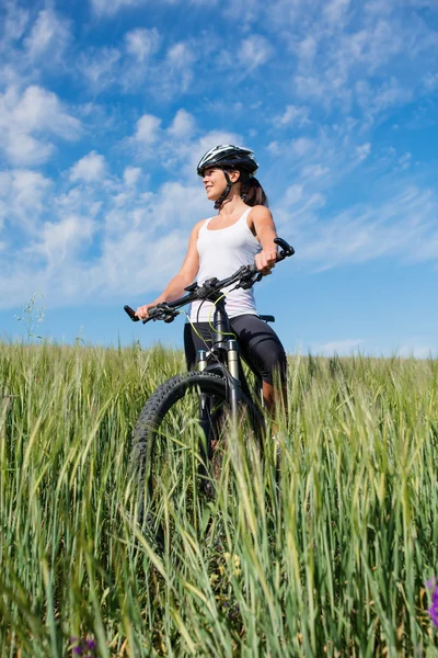 Girl rides a bicycle in the countryside