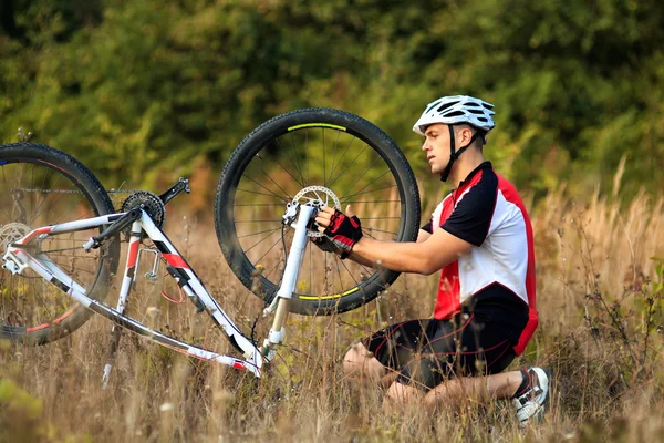 Bike repair. Young man repairing mountain bike