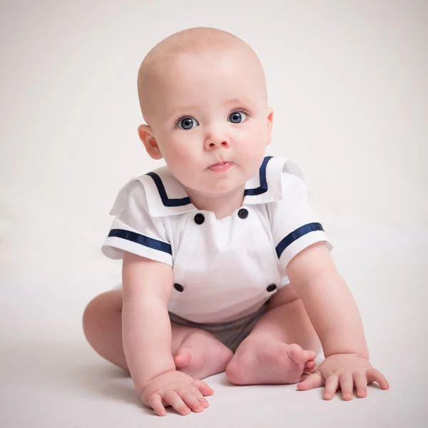 Baby Boy Sitting On Floor In Sailor Suit