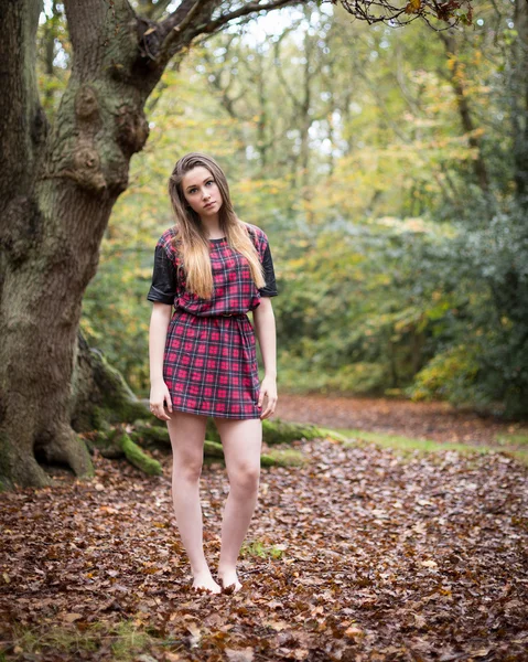 Portrait of a Beautiful Teenage Girl Standing in a Forest