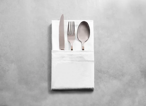 Blank white restaurant cloth napkin mockup with silver cutlery set