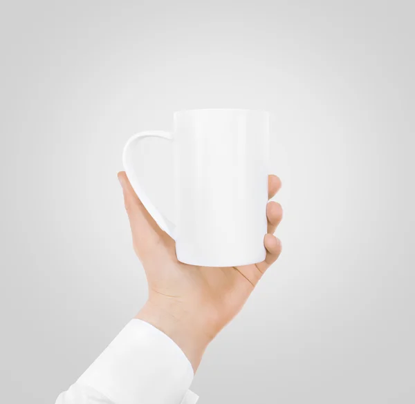 White blank mug mock up holding hand isolated.