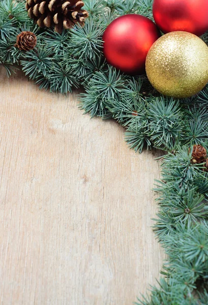 Christmas decoration fir tree and ornaments on wooden background
