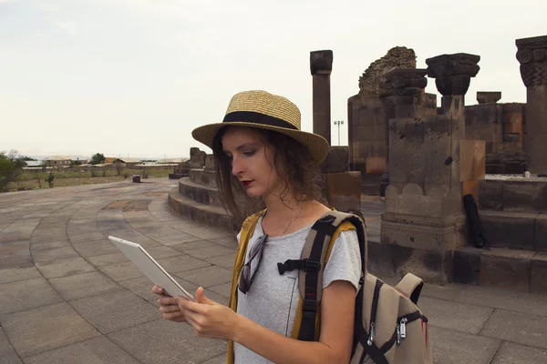 Beautiful girl student using tablet for distance education during traveling. Mobility, technology and travel concept.