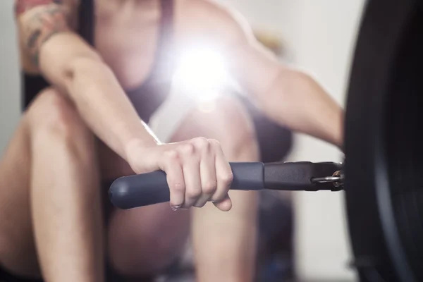 Girl working out on rowing machine