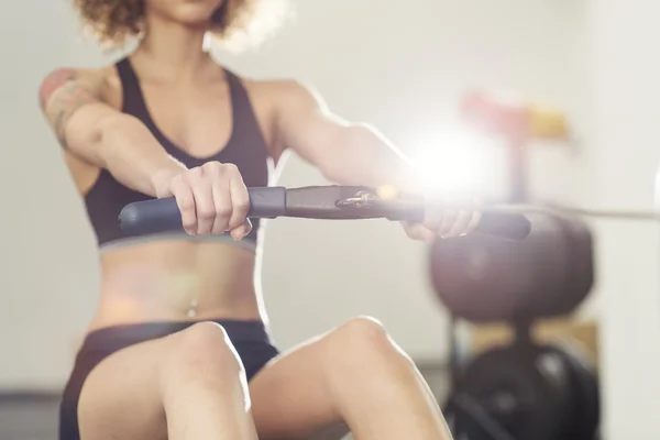 Girl working out on rowing machine