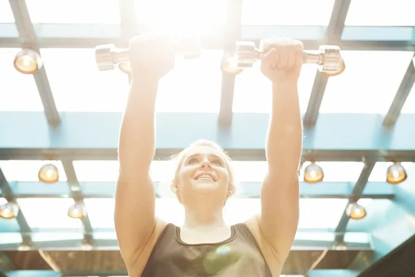 Girl working out with dumbbells