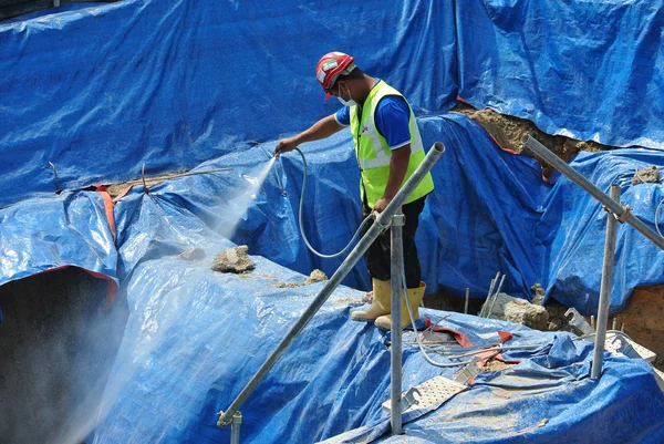 Construction workers spraying the anti termite chemical treatment