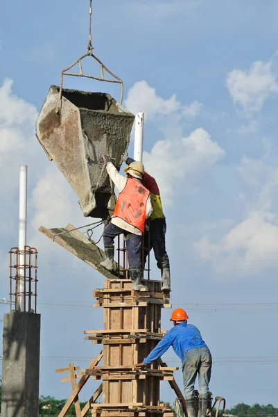 Construction workers casting column