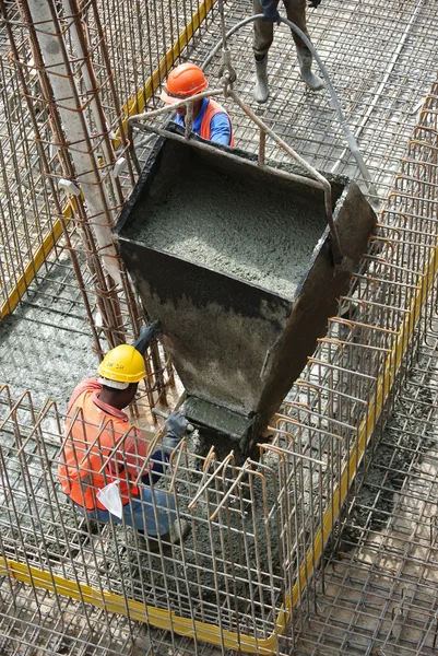 Group of construction workers casting ground floor slab