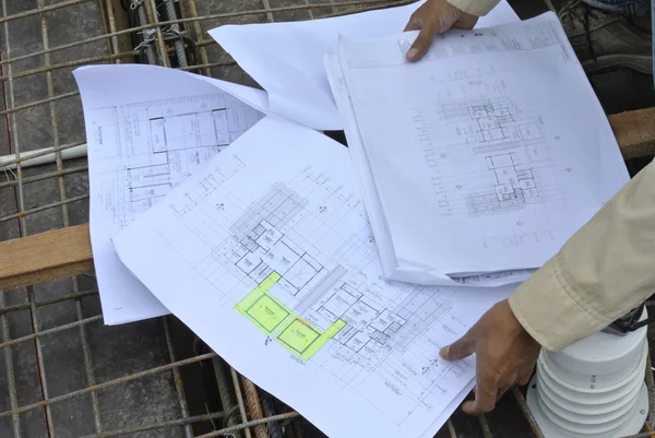 Construction worker referring to the construction drawing